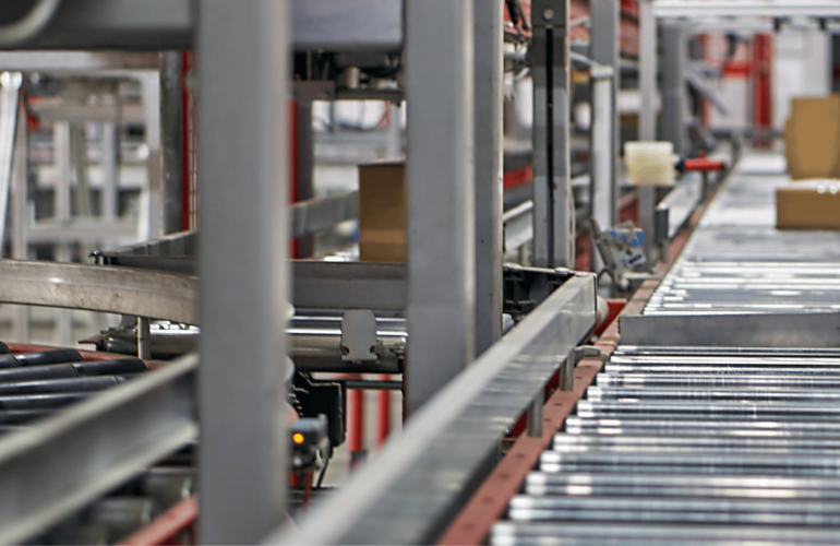 A conveyor belt in motion in a manufacturing facility